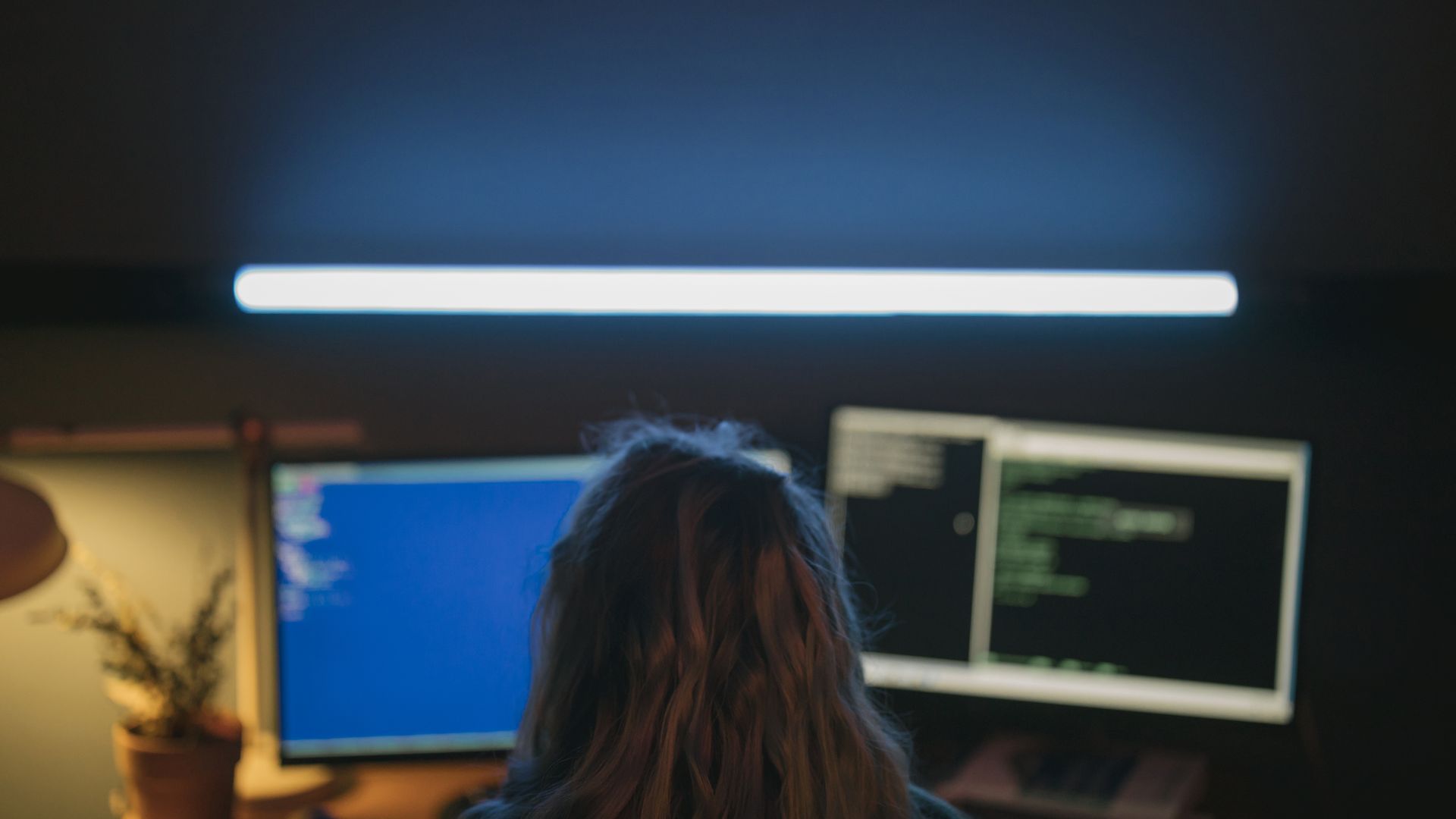 Software developer building in a focused dual-screen coding environment
